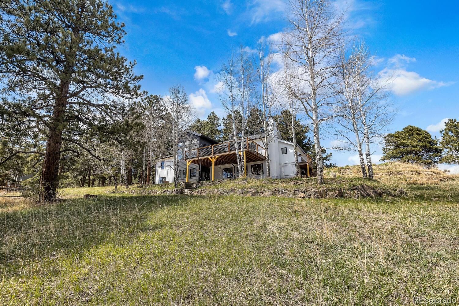 22398 Blue Jay Road Morrison, CO 80465 - Photo 35 of 39 a view of a house with a yard