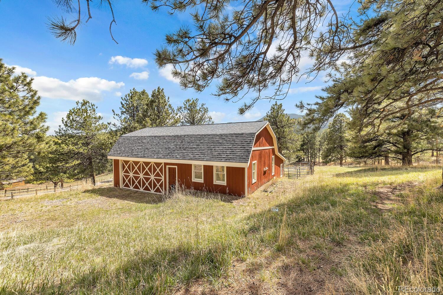 22398 Blue Jay Road Morrison, CO 80465 - Photo 36 of 39 a view of a house with a yard and tree s