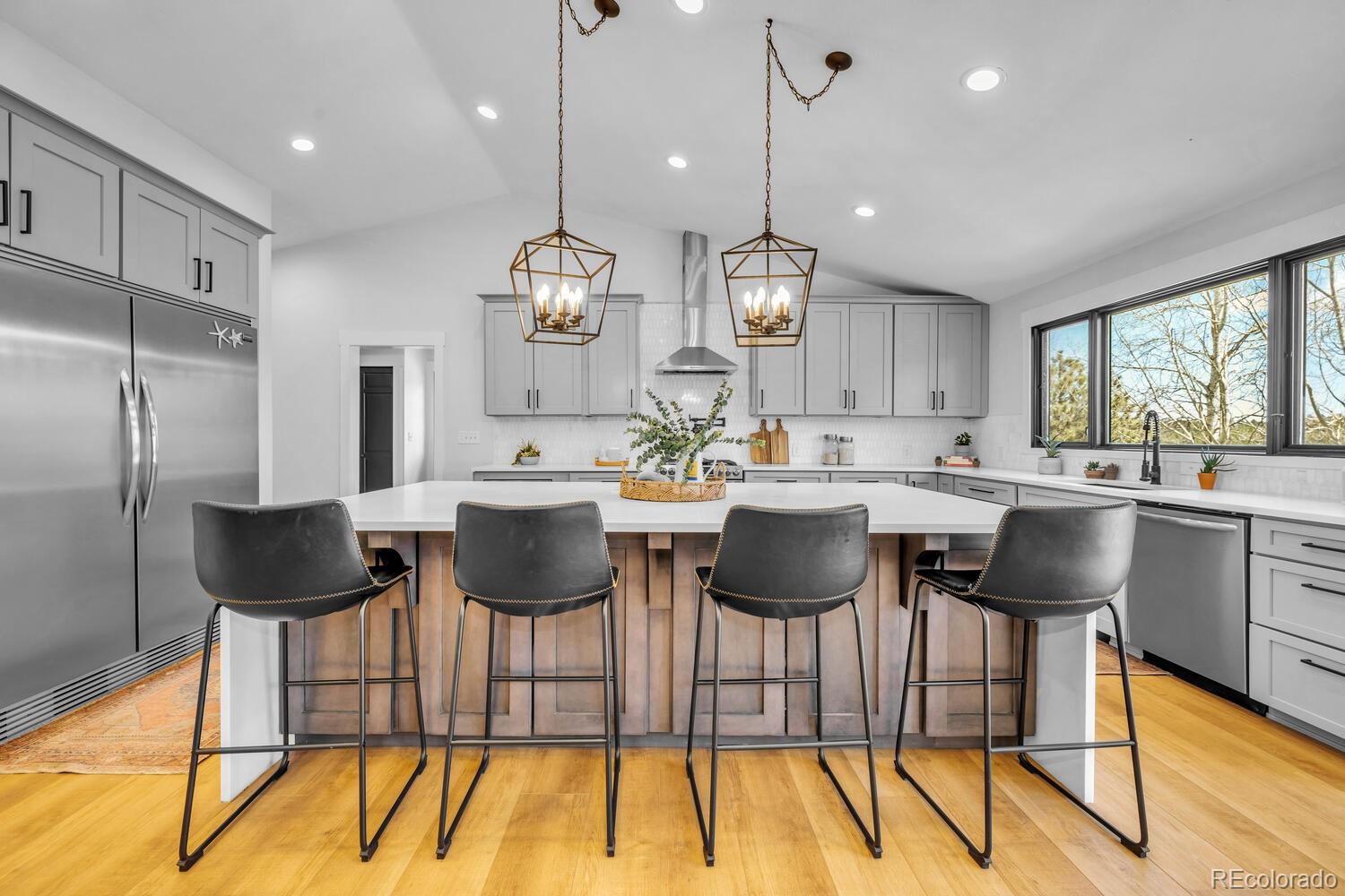 22398 Blue Jay Road Morrison, CO 80465 - Photo 5 of 39 a kitchen with a dining table chairs sink and cabinets