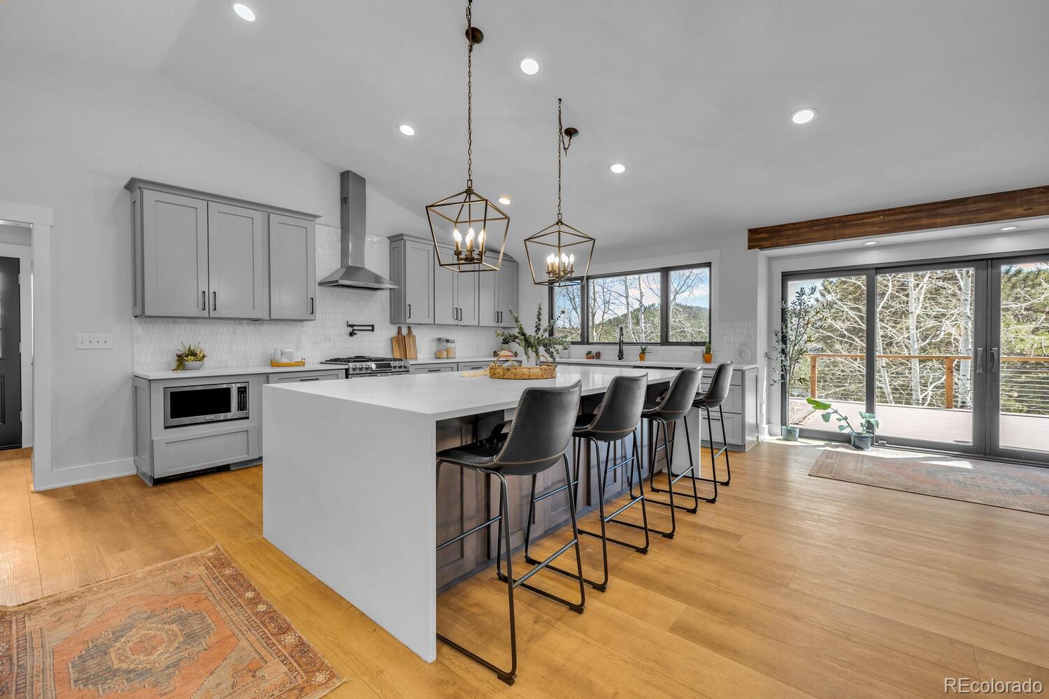 22398 Blue Jay Road Morrison, CO 80465 - Photo 8 of 39 a large kitchen with lots of counter space a sink and appliances