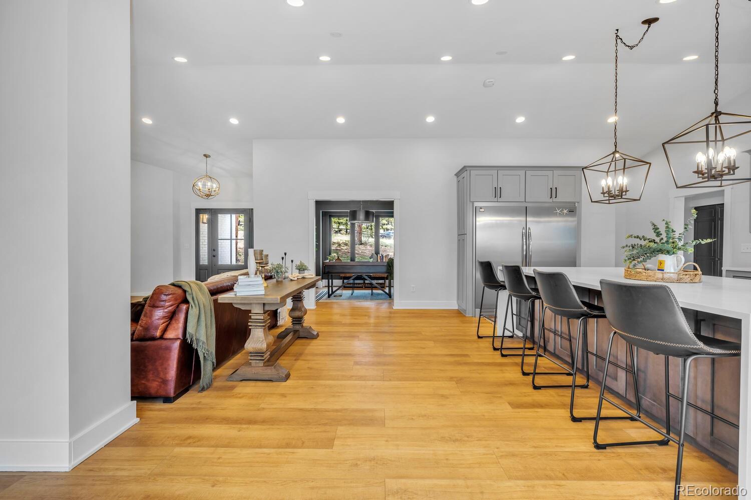 22398 Blue Jay Road Morrison, CO 80465 - Photo 10 of 39 a living room with dining room and wooden floor