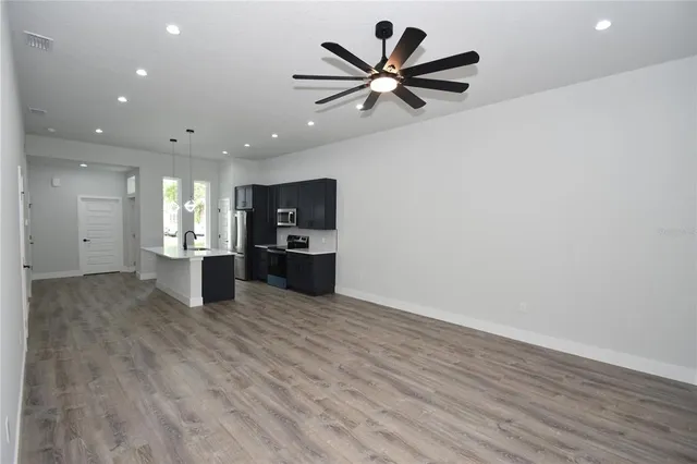 a view of a kitchen with a sink and microwave