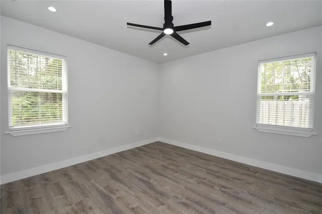 a view of a room with a window and a ceiling fan