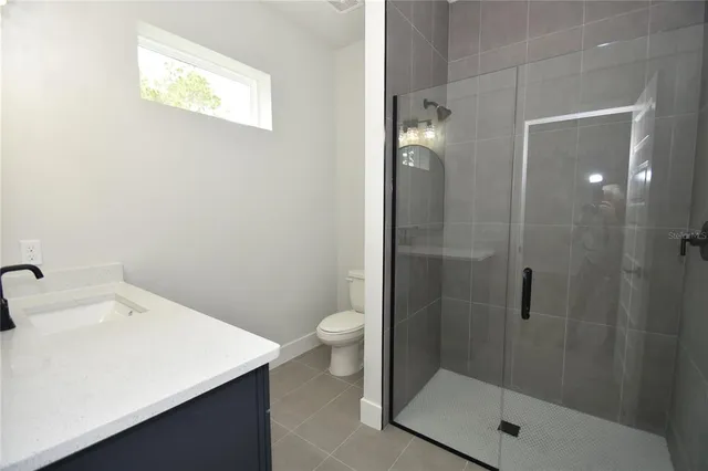 a bathroom with a shower sink and toilet