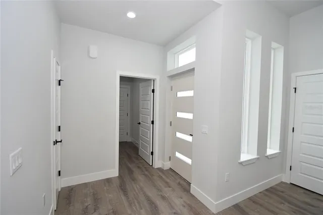 a view of empty room with wooden floor