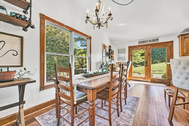 a very nice looking dining room with furniture window and wooden floor