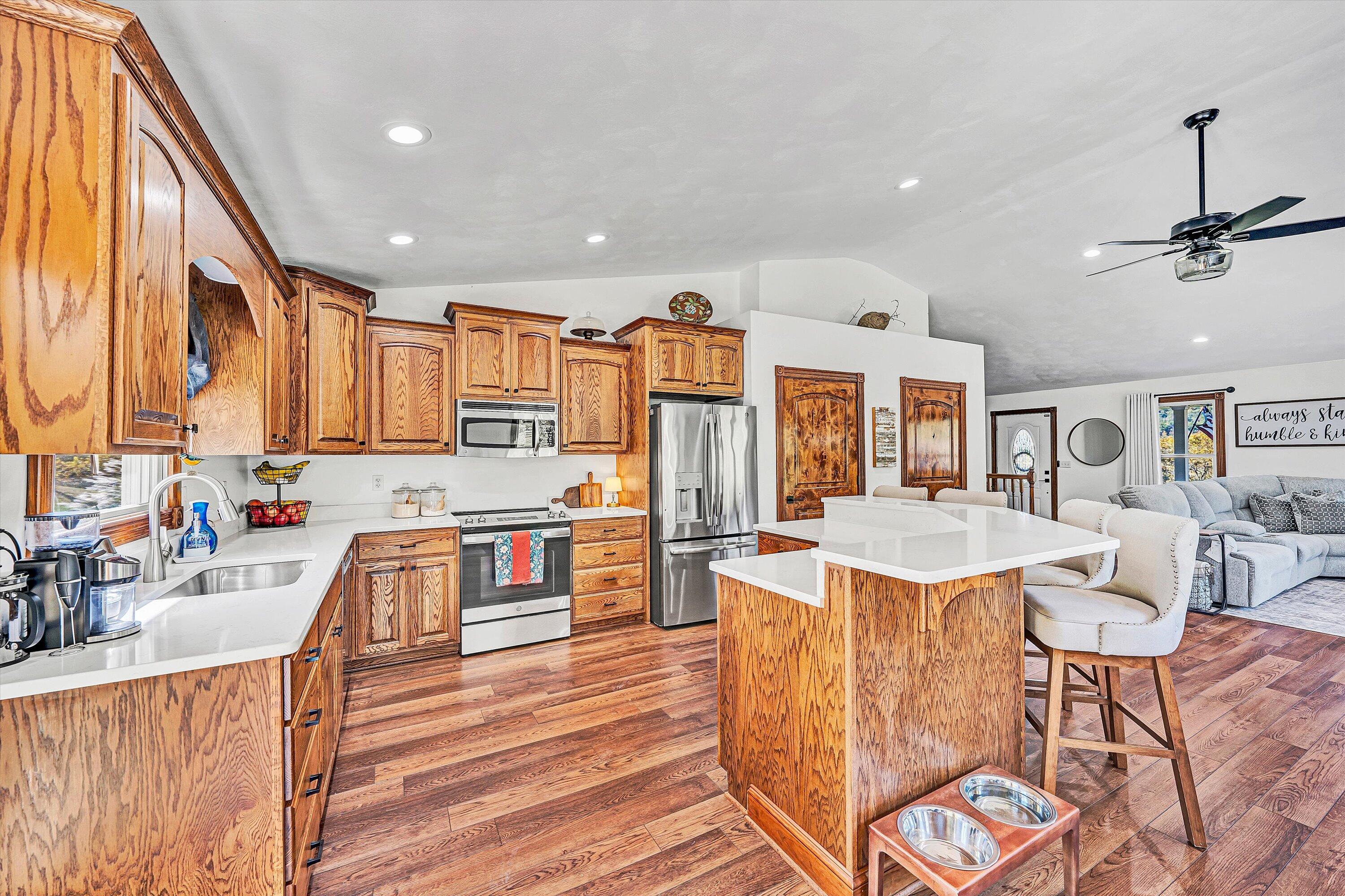 99 Spruce Lane Callaway, VA 24067 - Photo 15 of 66 a living room with stainless steel appliances kitchen island granite countertop furniture and a kitchen view