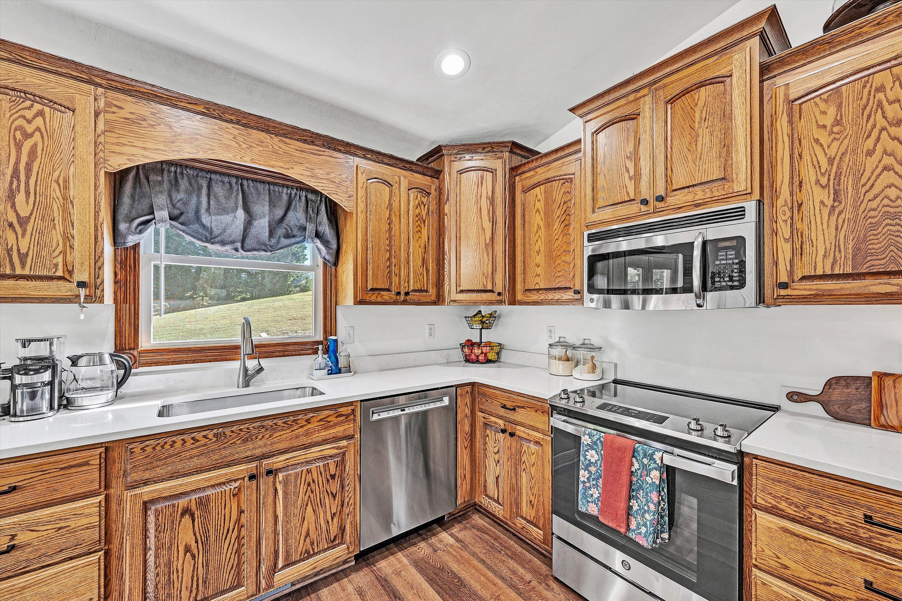 99 Spruce Lane Callaway, VA 24067 - Photo 17 of 66 a kitchen with stainless steel appliances granite countertop a sink stove and cabinets