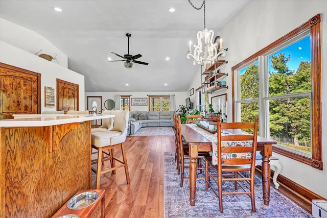 a spacious bathroom with a tub sink and mirror