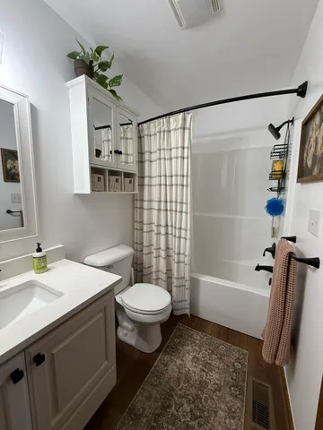 a bathroom with a toilet and shower