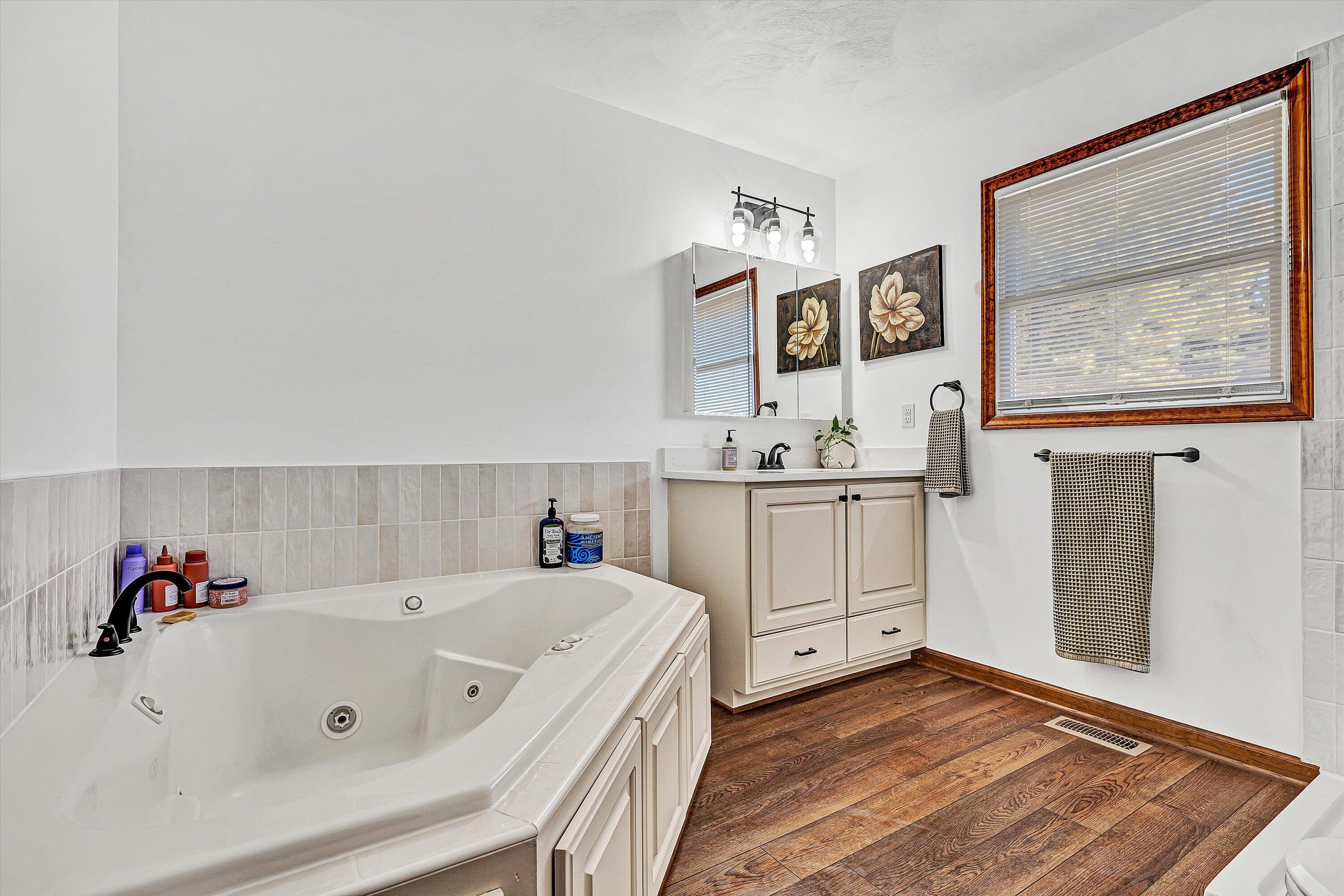 99 Spruce Lane Callaway, VA 24067 - Photo 30 of 66 a spacious bathroom with a tub sink and mirror
