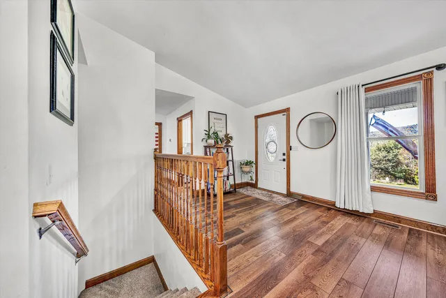 a living room with furniture a wooden floor and window
