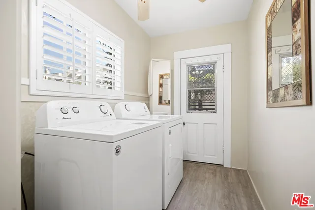 a view of a dining room with furniture a chandelier and wooden floor