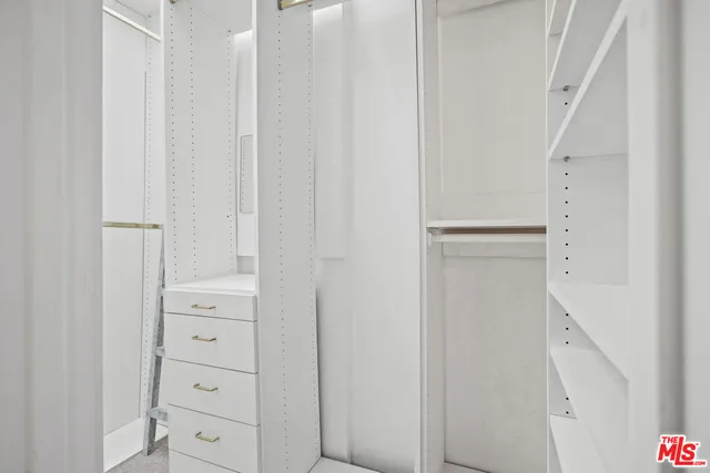 a bedroom with a bed and a lamp