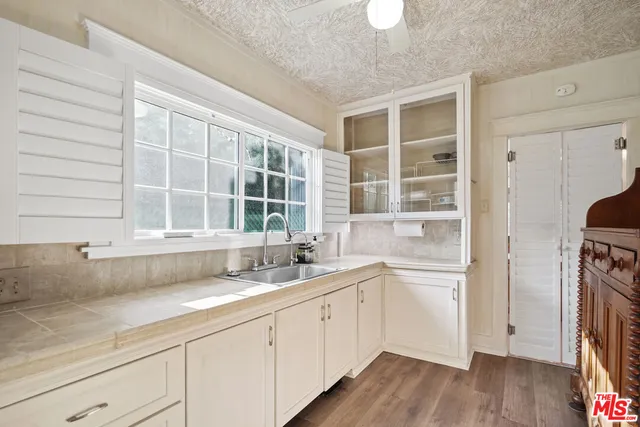 a view of a patio with a table and chairs under an umbrella