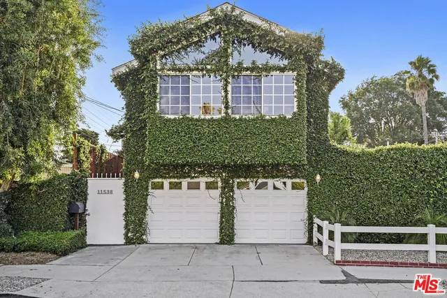 a living room with furniture a flat screen tv and a large window