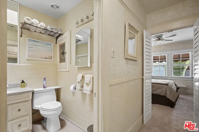 a view of a patio with a table and chairs under an umbrella