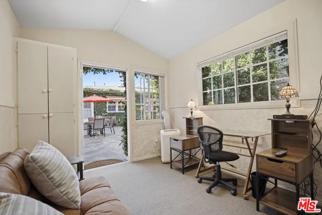 a view of a patio with table and chairs under an umbrella