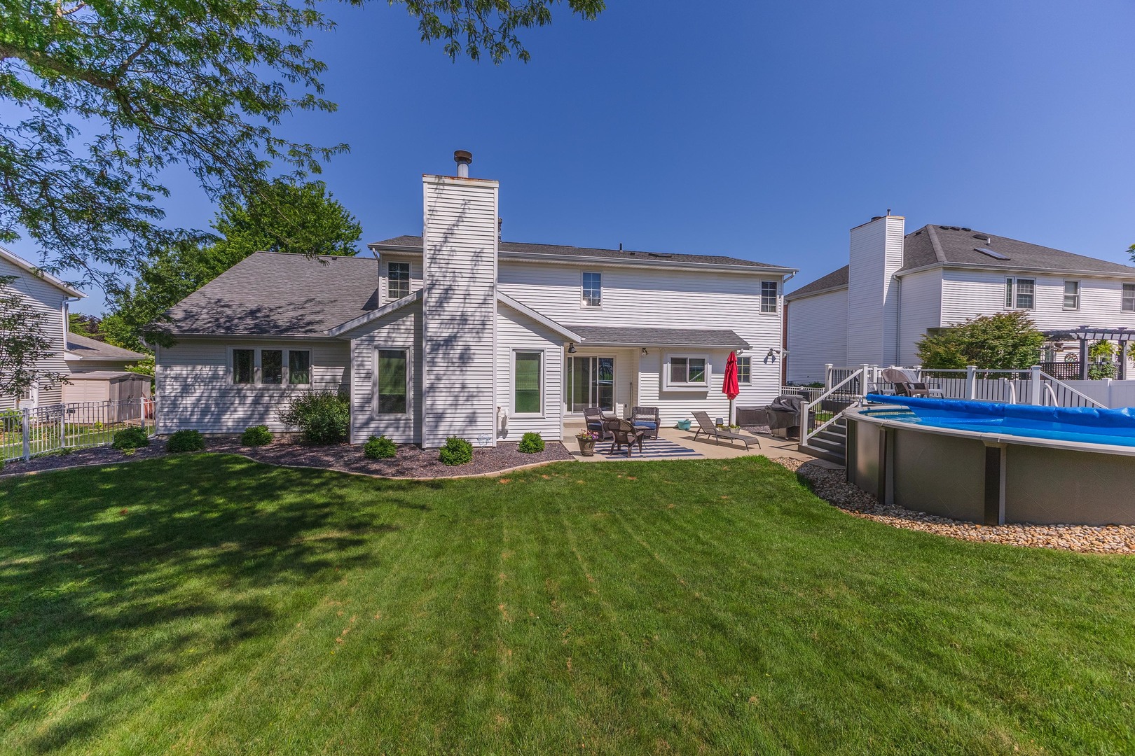 2605 Park Ridge Road Bloomington, IL 61704 - Photo 28 of 69 a front view of a house with swimming pool having outdoor seating