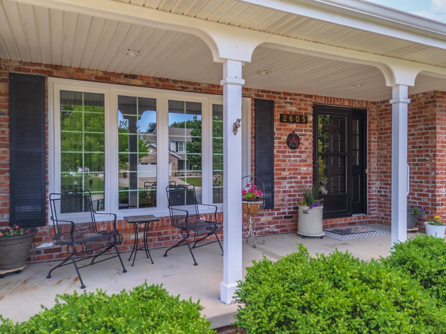 2605 Park Ridge Road Bloomington, IL 61704 - Photo 3 of 69 a view of a building with sitting area and bench