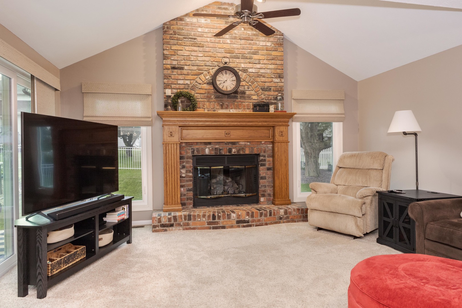 2605 Park Ridge Road Bloomington, IL 61704 - Photo 47 of 69 a living room with furniture a flat screen tv and a fireplace