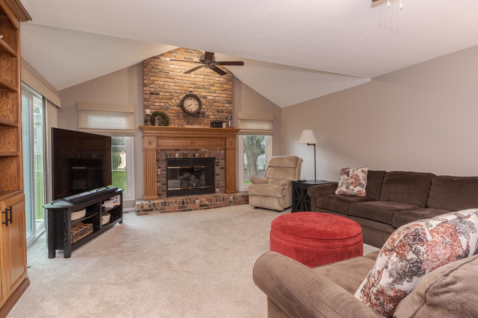 2605 Park Ridge Road Bloomington, IL 61704 - Photo 49 of 69 a living room with furniture a flat screen tv and a fireplace