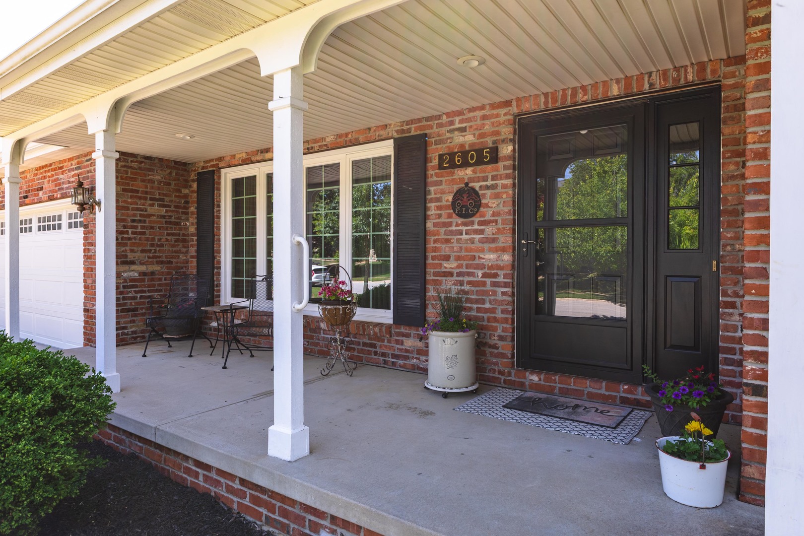 2605 Park Ridge Road Bloomington, IL 61704 - Photo 5 of 69 a view of a patio with table and chairs and potted plants