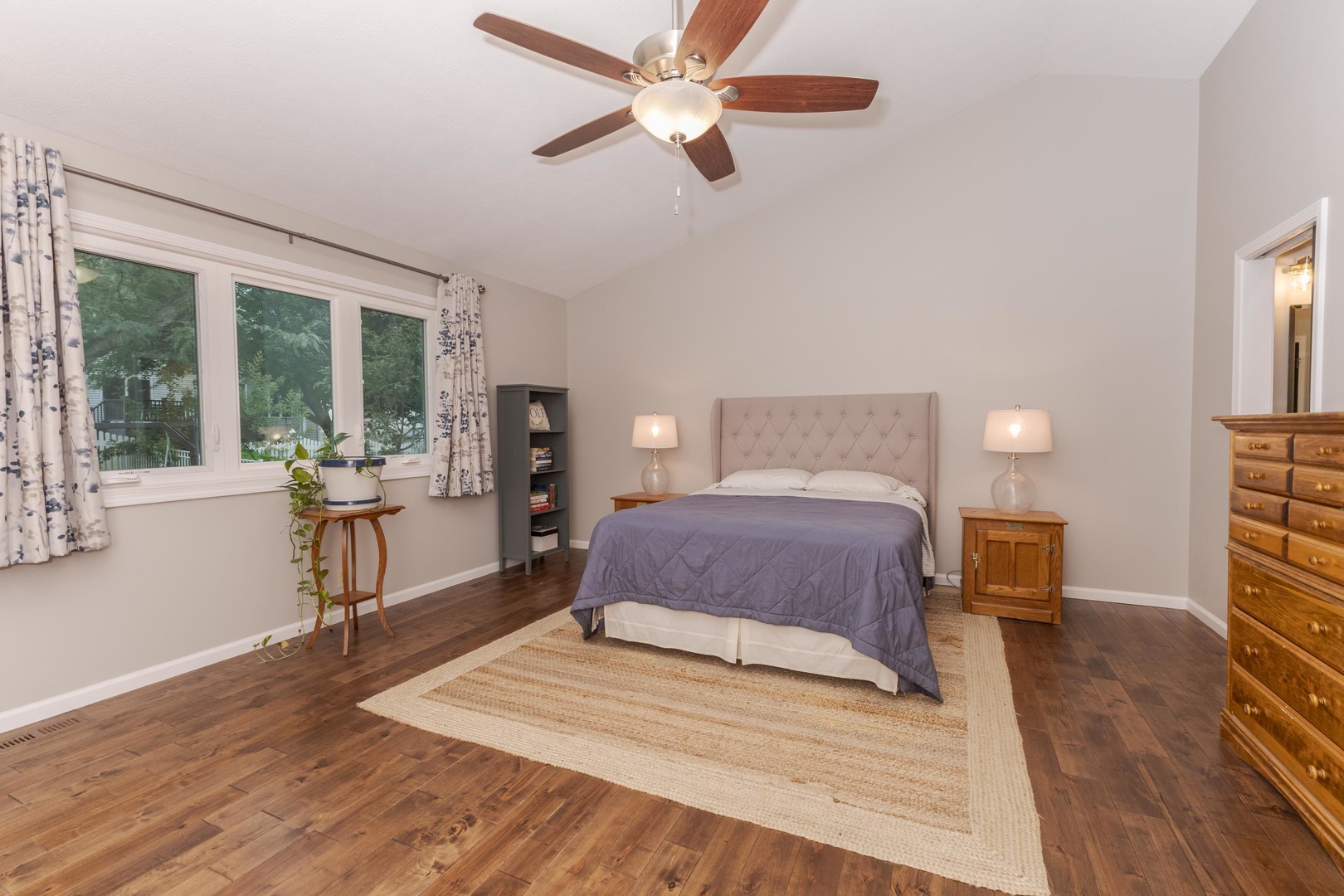 2605 Park Ridge Road Bloomington, IL 61704 - Photo 55 of 69 a bedroom with a large bed and a chandelier