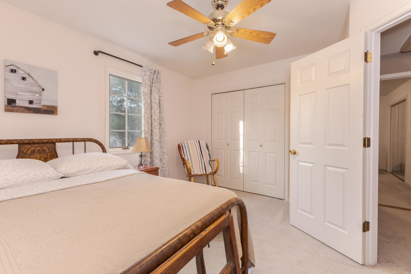 2605 Park Ridge Road Bloomington, IL 61704 - Photo 64 of 69 a bedroom with a bed and a chandelier