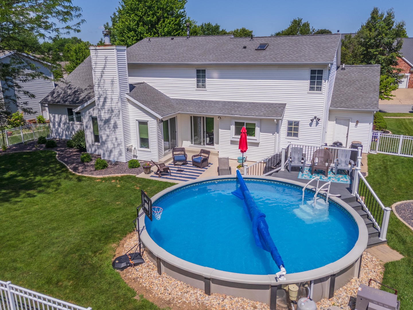 2605 Park Ridge Road Bloomington, IL 61704 - Photo 10 of 69 a view of a backyard with table and chairs potted plants and a large tree