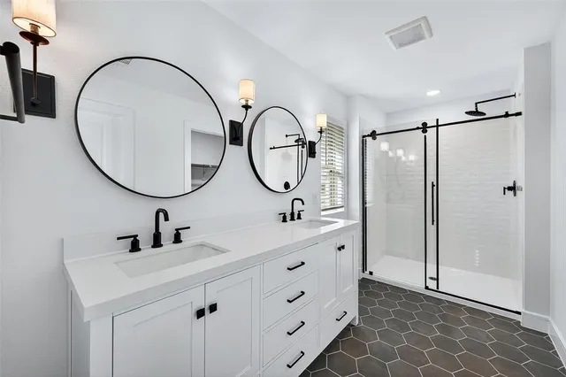a bathroom with 2 sink and a mirror