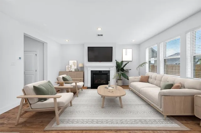 a living room with furniture a fireplace and a flat screen tv