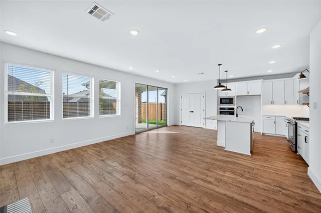 a view of kitchen with cabinets and wooden floor