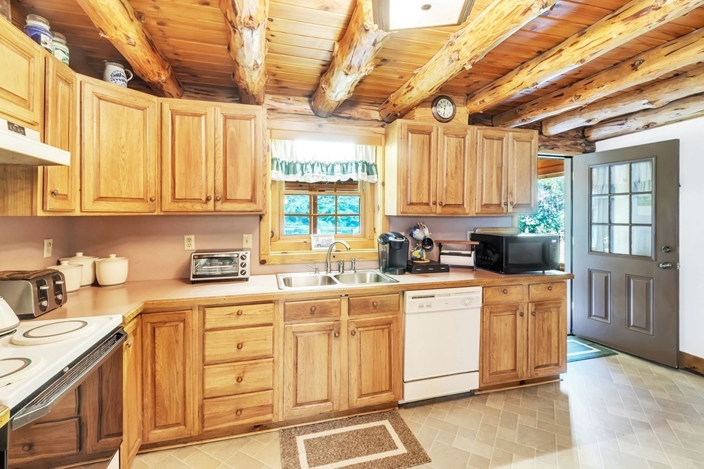 160 Laurel Hill Road Westhampton, MA 01027 - Photo 13 of 42 a kitchen with stainless steel appliances granite countertop a stove a sink dishwasher and cabinets with wooden floor
