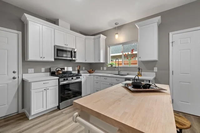 a kitchen with a sink stove and cabinets
