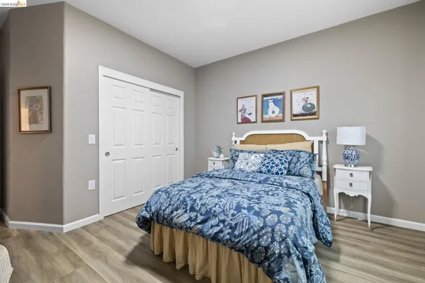 a bedroom with bed and a chandelier