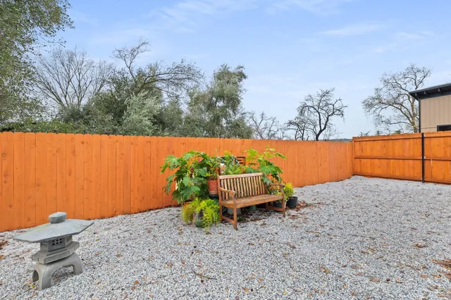 a backyard of a house with table and chairs