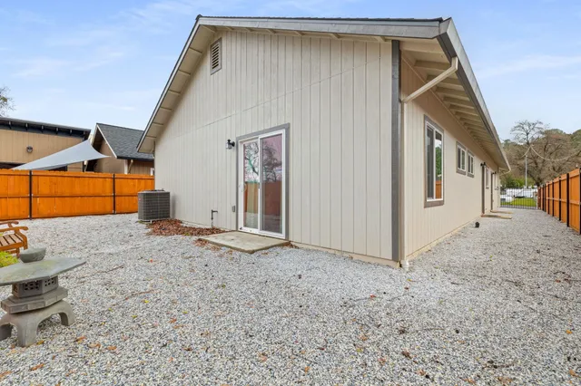 a backyard of a house with garage and outdoor seating