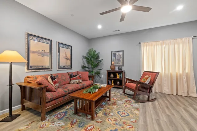 a living room with furniture and wooden floor