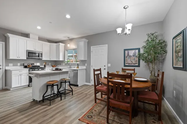 a kitchen with white cabinets and appliances