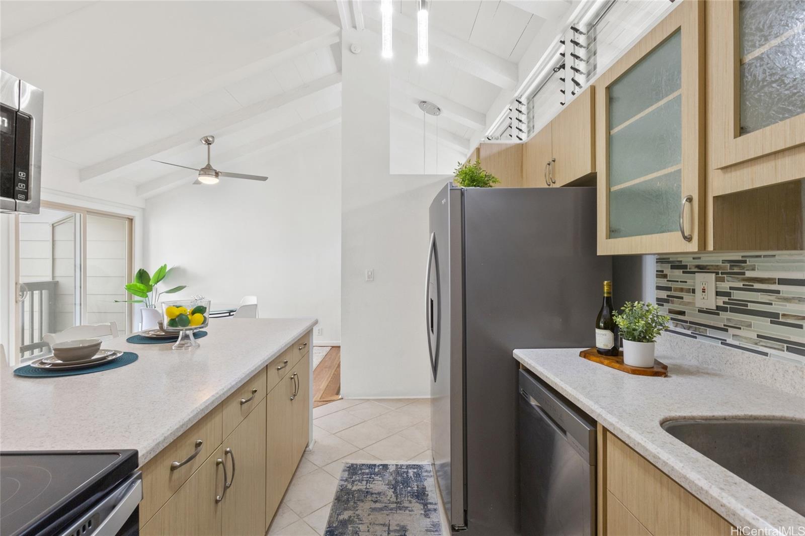 45-995 Wailele Road, Unit 29 Kaneohe, HI 96744 - Photo 12 of 25 a kitchen with a sink a counter and cabinets