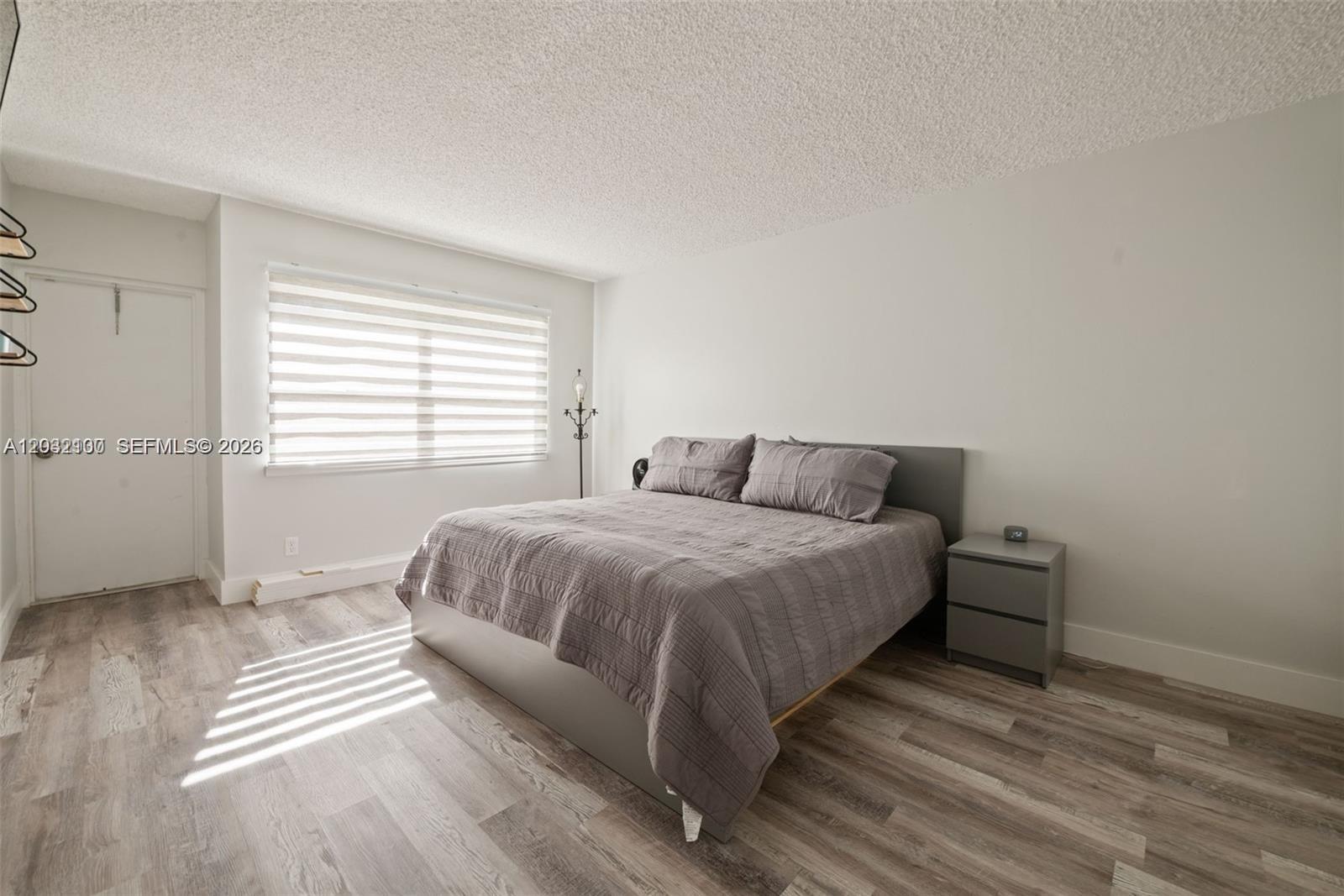 301 Racquet Club Road, Unit 104 Weston, FL 33326 - Photo 8 of 21 a bedroom with a bed and a window
