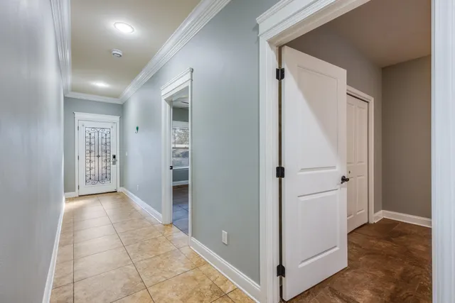 a view of a hallway with closet and a bathroom