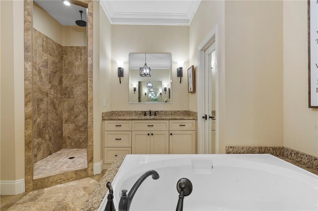 2995 Gum Creek Road Oxford, GA 30054 - Photo 25 of 51 a bathroom with a granite countertop sink a mirror and shower