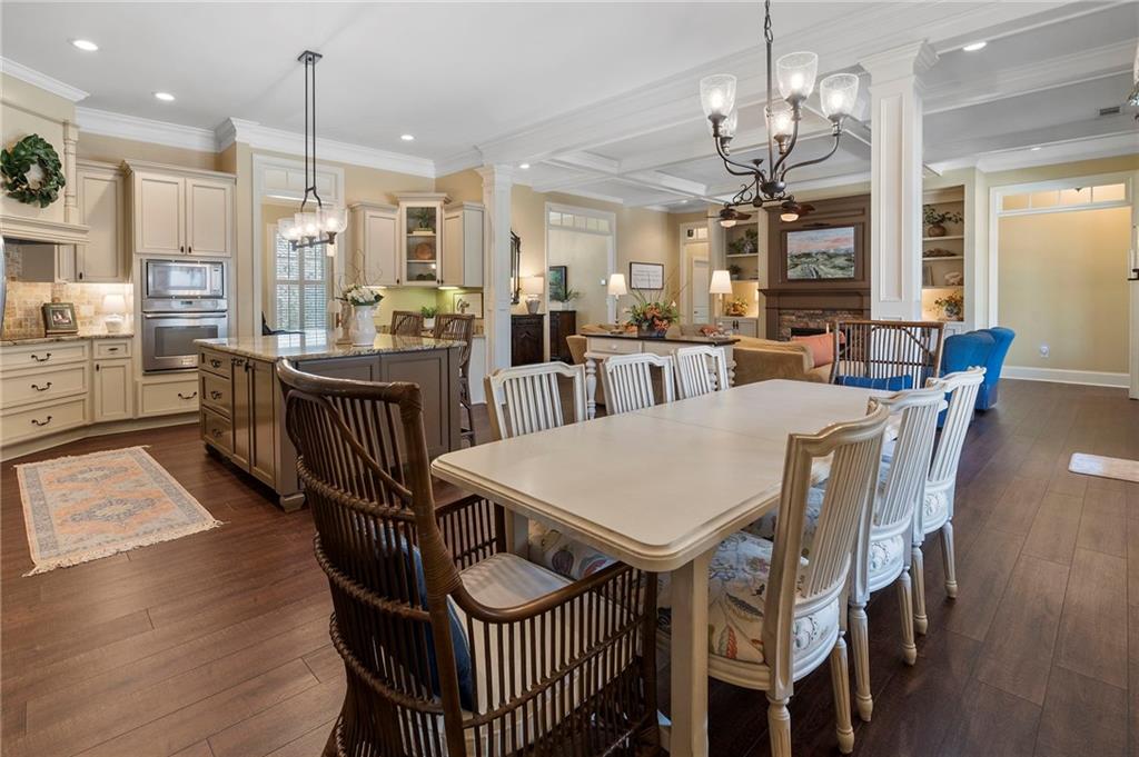2995 Gum Creek Road Oxford, GA 30054 - Photo 7 of 59 a view of a dining room with furniture a chandelier and wooden floor