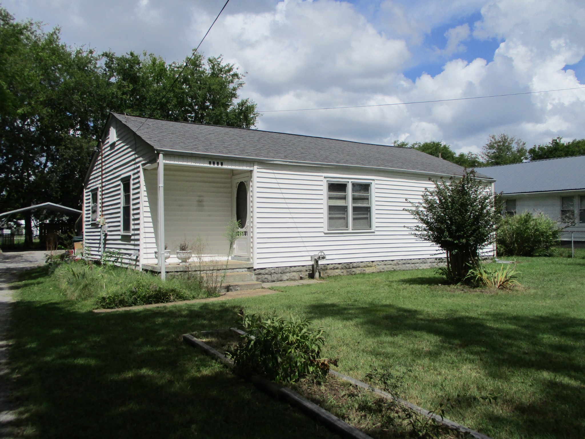 1003 Hickory Ridge Road Lebanon, TN 37087 - Photo 1 of 18 a backyard of a house with plants and barbeque oven