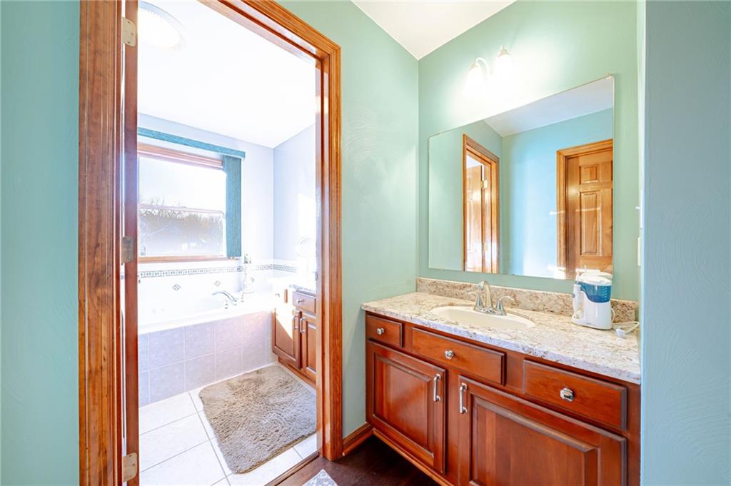 220 Tiffany Irwin, PA 15642 - Photo 17 of 39 a bathroom with a granite countertop sink and a mirror