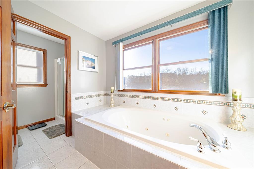 220 Tiffany Irwin, PA 15642 - Photo 18 of 39 a bathroom with a bathtub and a shower