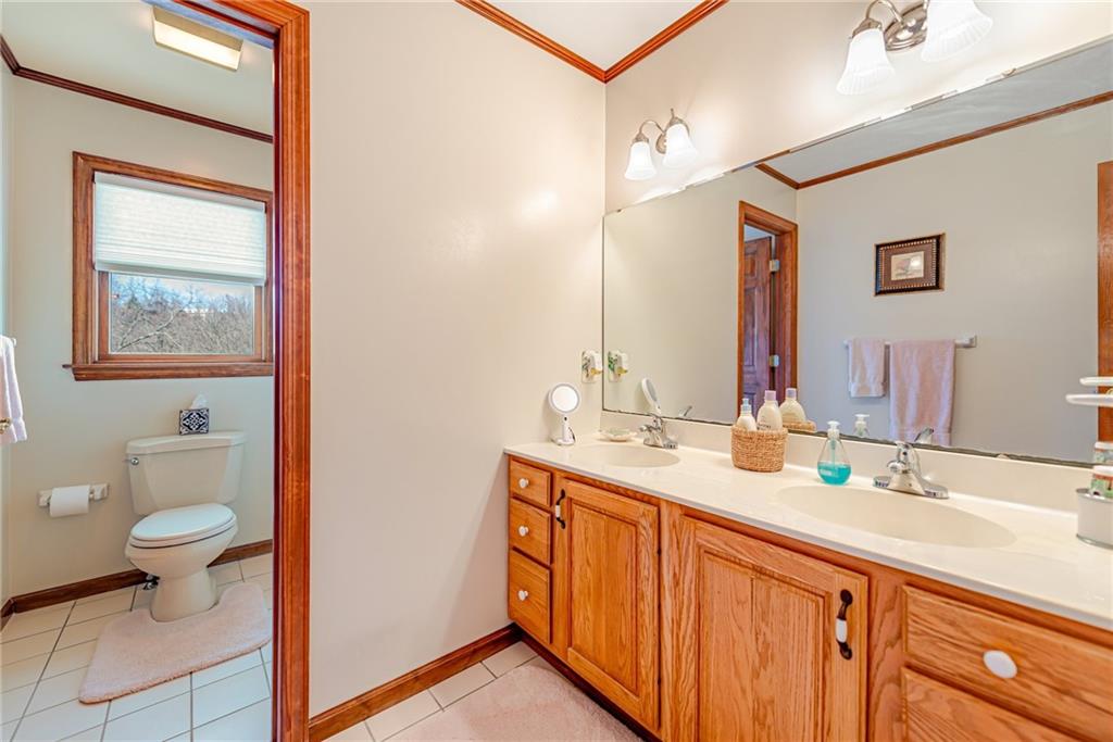 220 Tiffany Irwin, PA 15642 - Photo 26 of 39 a bathroom with a double vanity sink and a mirror