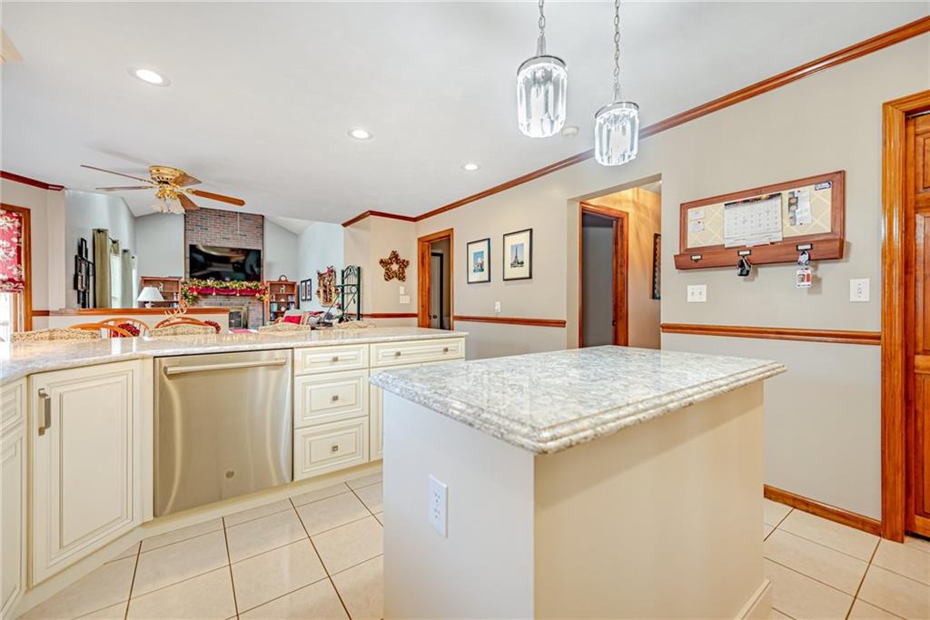 220 Tiffany Irwin, PA 15642 - Photo 7 of 39 a kitchen view with stainless steel appliances kitchen island granite countertop a sink and cabinets